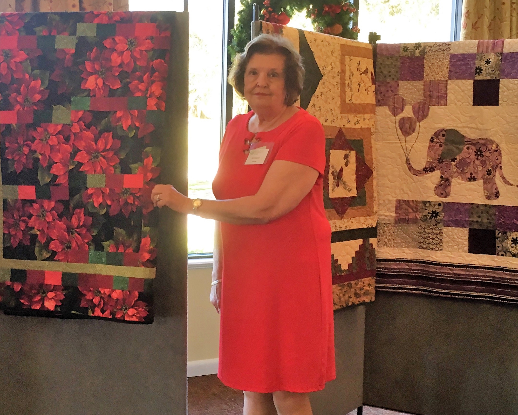 Janice Scanlon shows off quilts to be raffled.