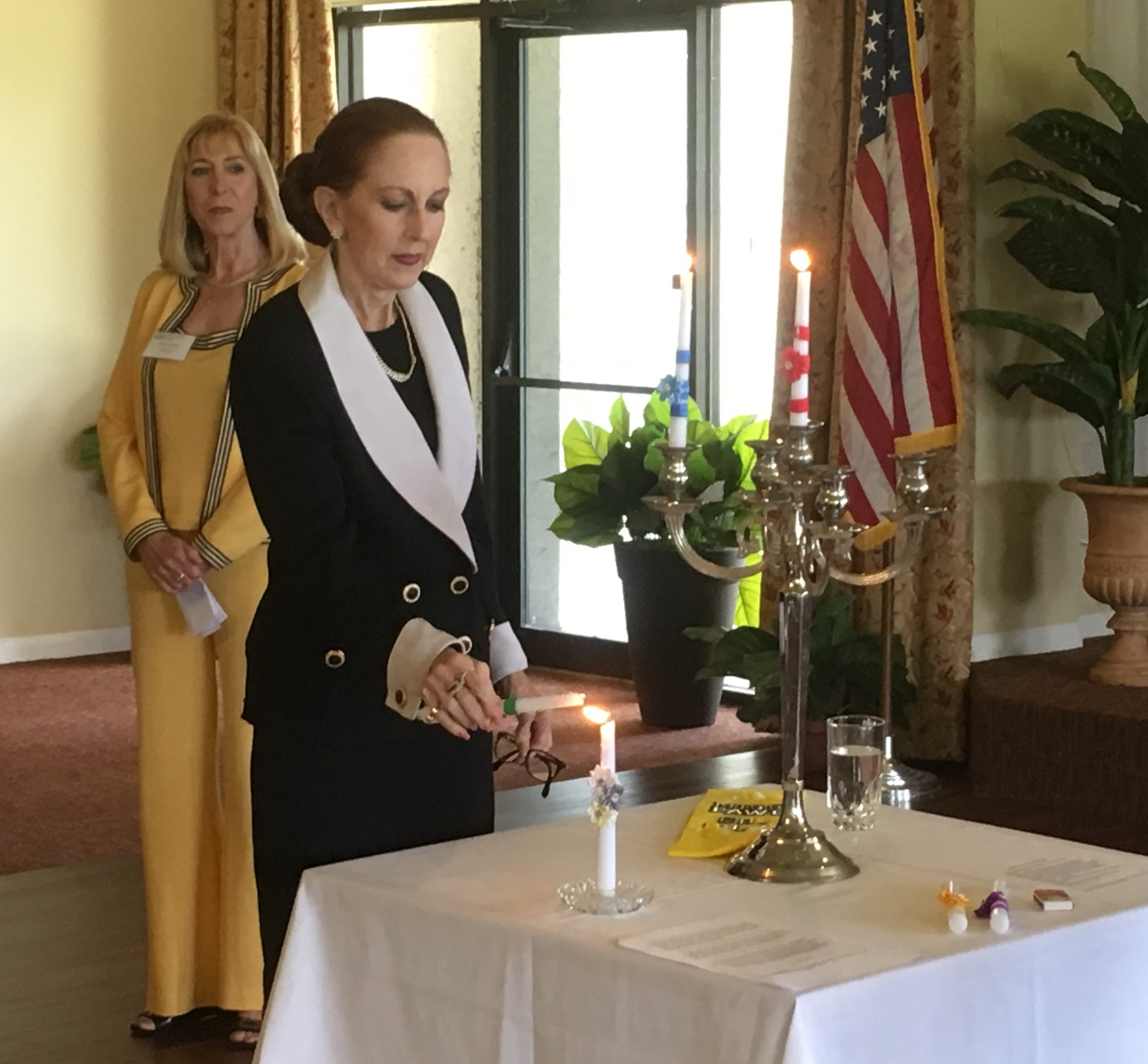 Susan Romine lights the ceremonial candle