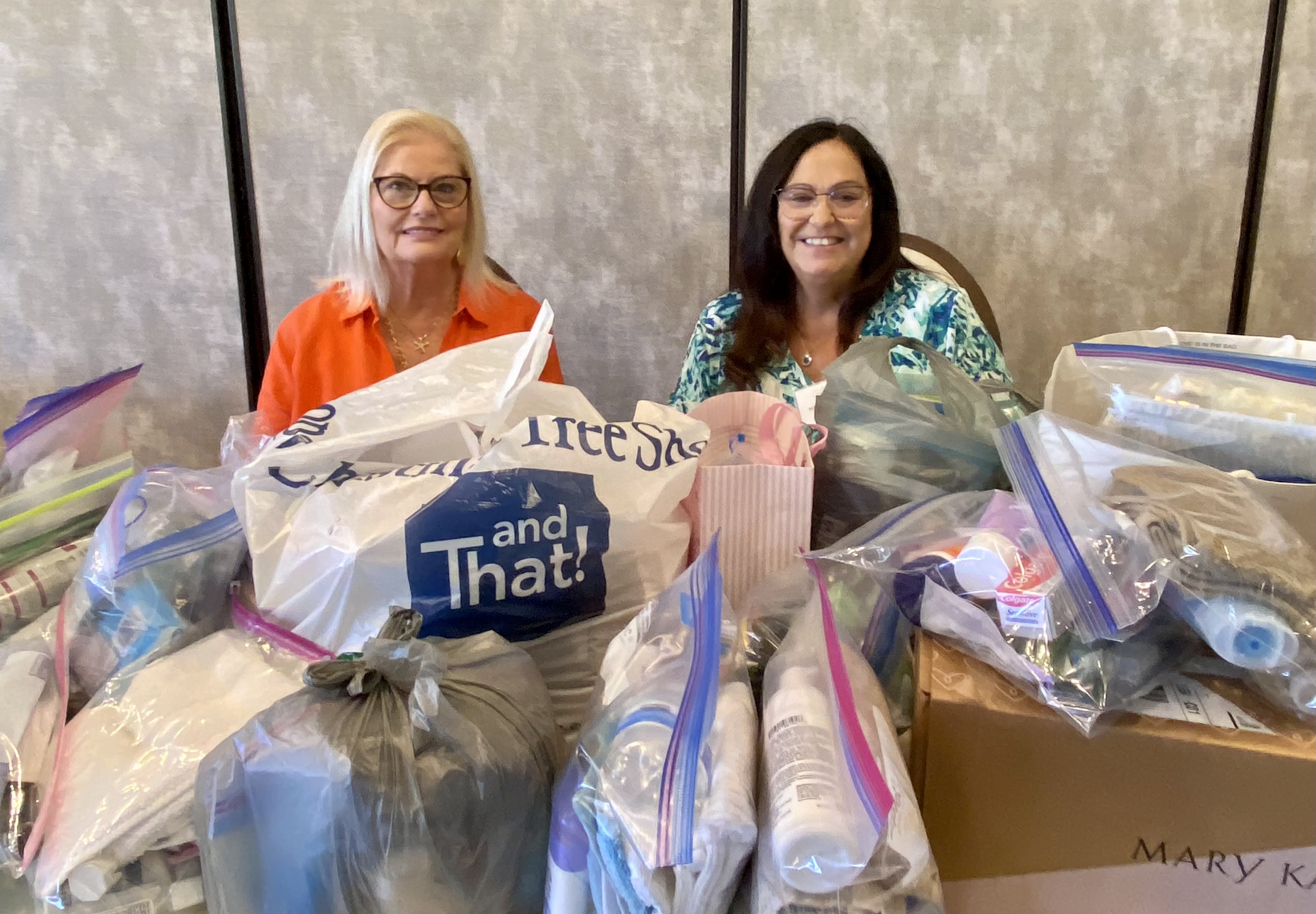Candice Holloway and MaryBeth Rempp collected supplies for Resurrection House at the April Luncheon.